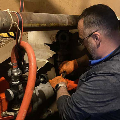 Person Working On Pipes